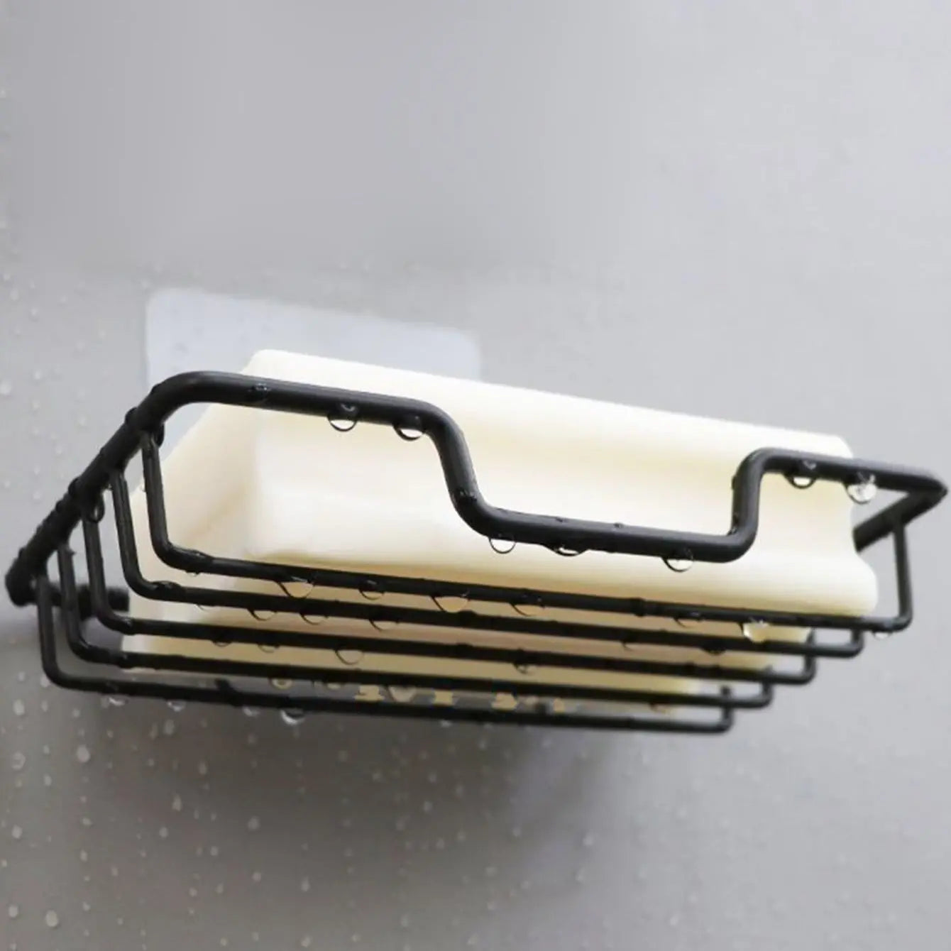 Clarify.pk black metal wall mounted soap holder with white soap bar and water droplets