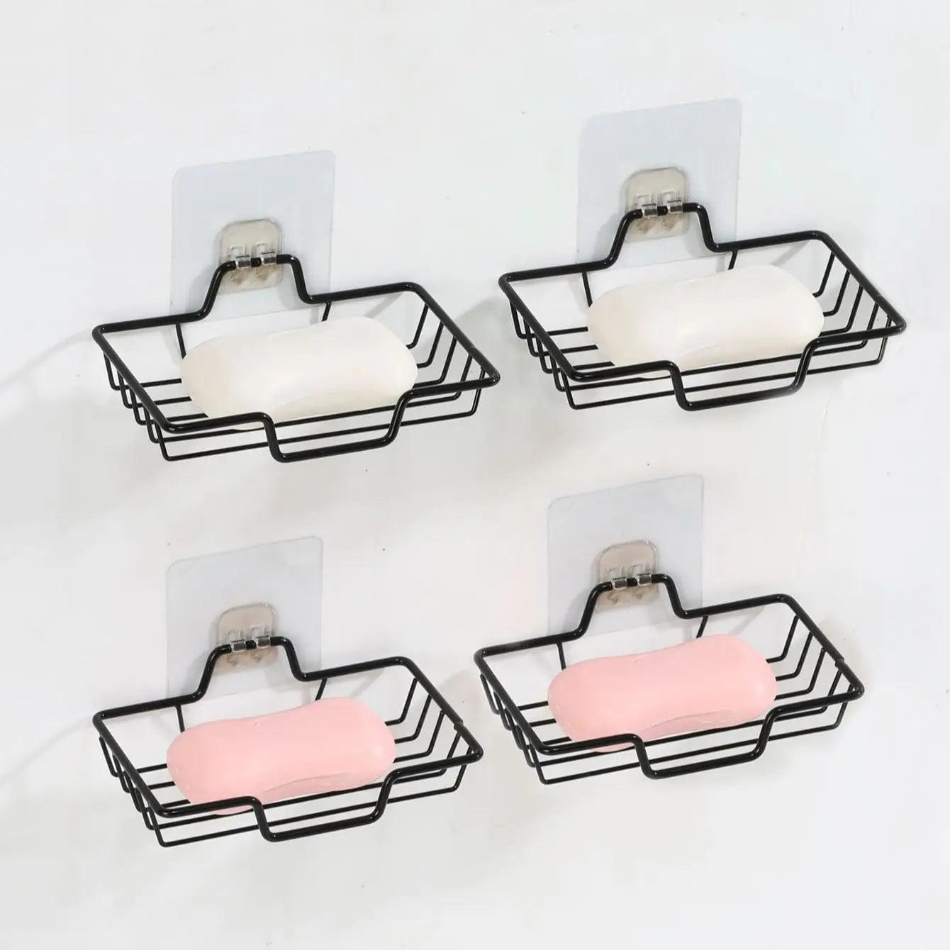 Clarify.pk black metal wall mounted soap holder with white and pink soap bars mounted on white wall