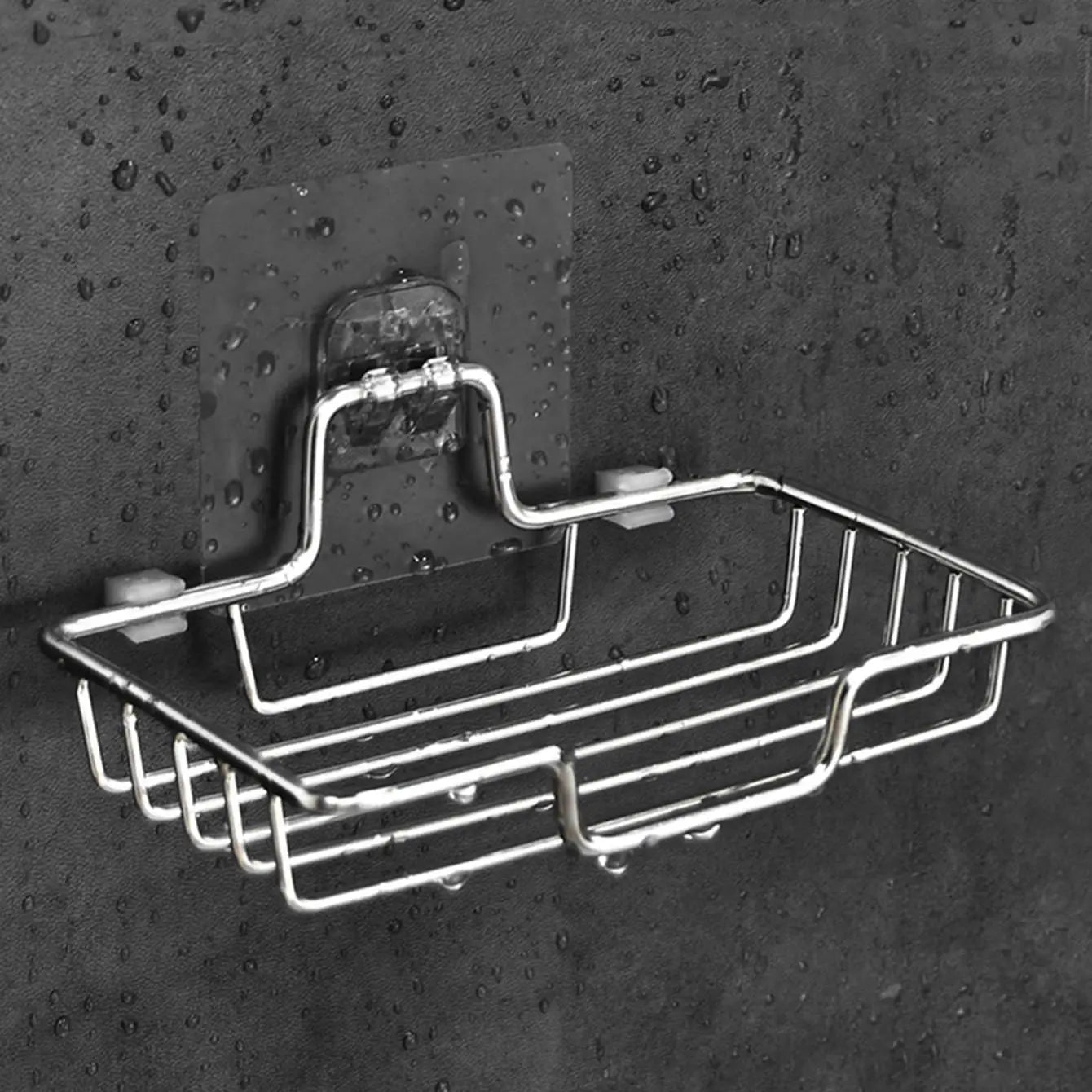 Clarify.pk stainless steel wall mounted soap holder with water droplets on black background