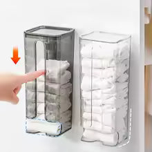 Clear wall mounted sock organizer holding multiple pairs of white socks with finger pointing to dispenser