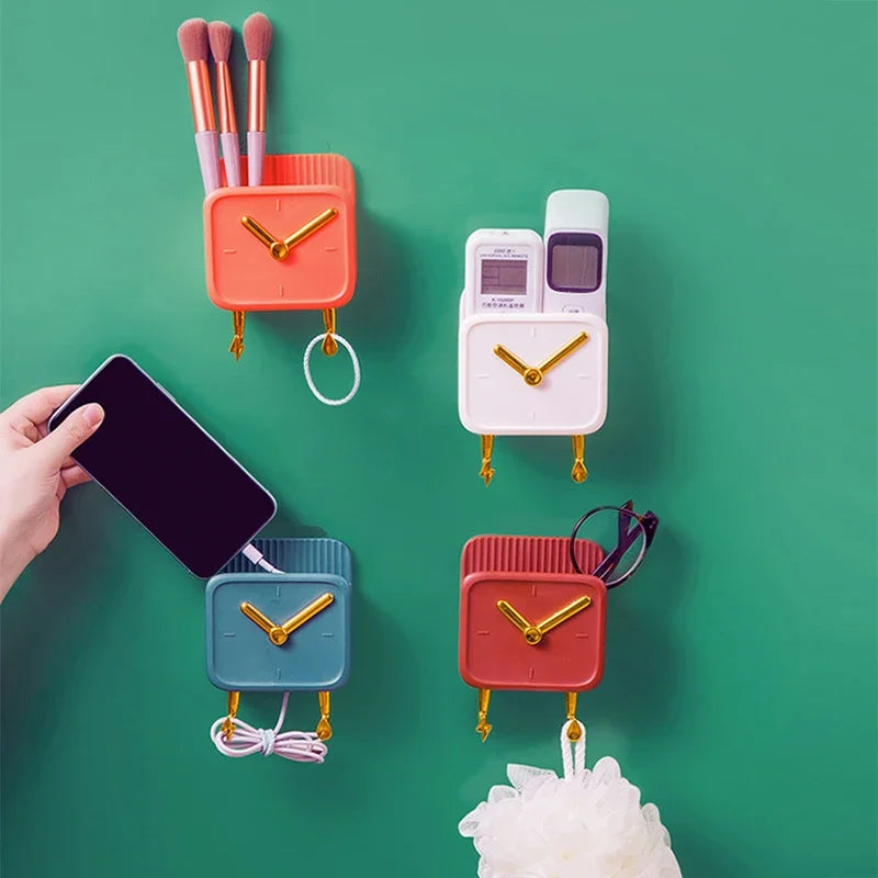 Colorful wall mounted storage box with clock feature holding brushes, remote, phone, glasses, and accessories