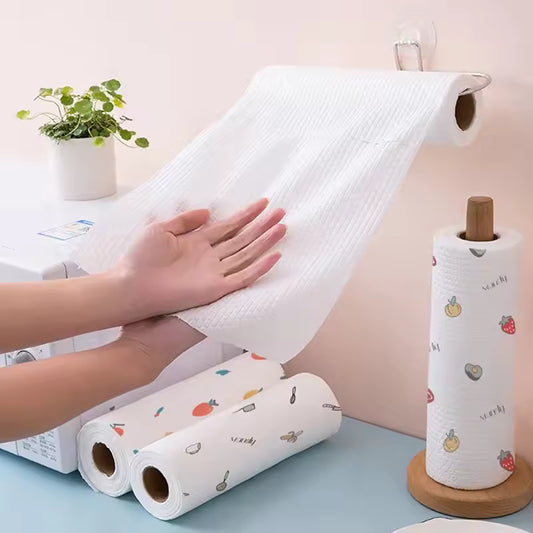 Washable kitchen hand tissue towels 50 sheets being pulled from a roll with decorative kitchen towel rolls on counter