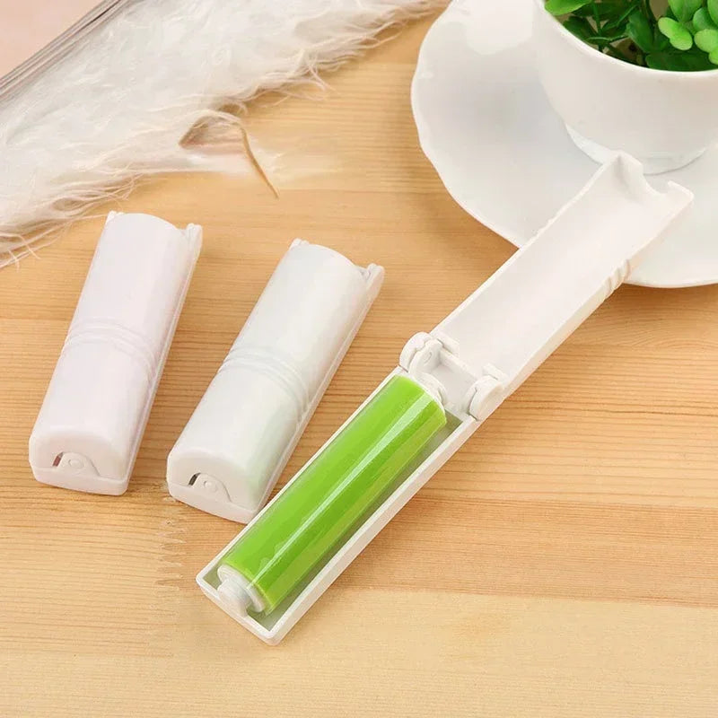 Washable lint remover brush with compact white case and green sticky roller on wooden surface
