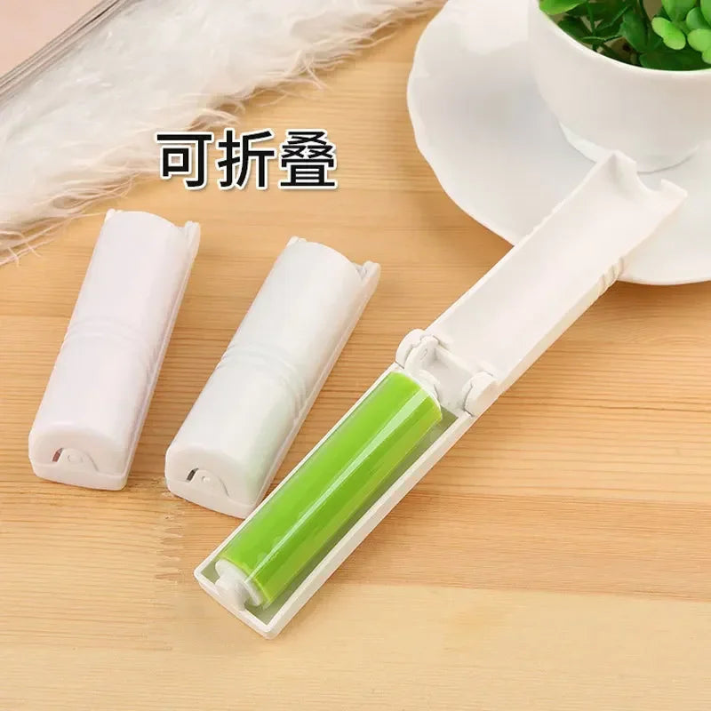 Washable lint remover brush in white folding case with green roller on wooden surface
