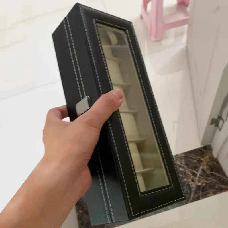 Elegant watch display case with lock, featuring a glass top and space for multiple watches