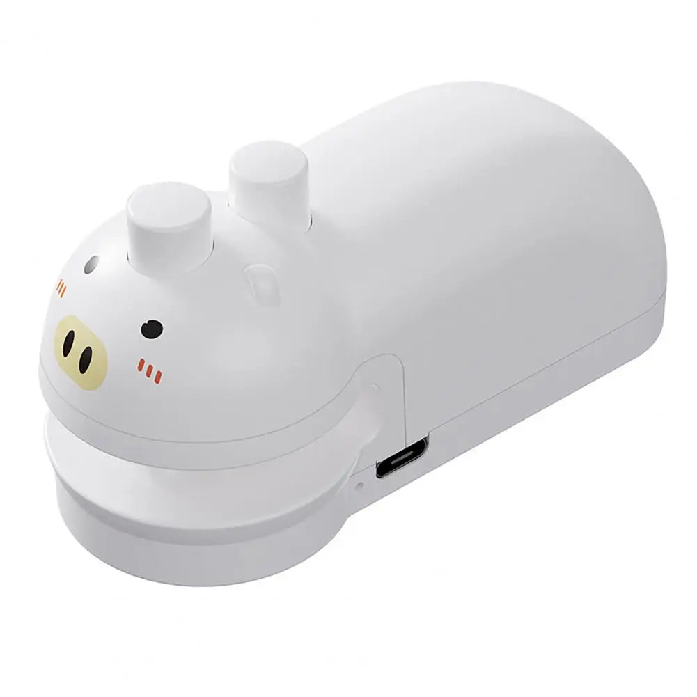 White handheld food sealing device with cute pig face design and USB charging port