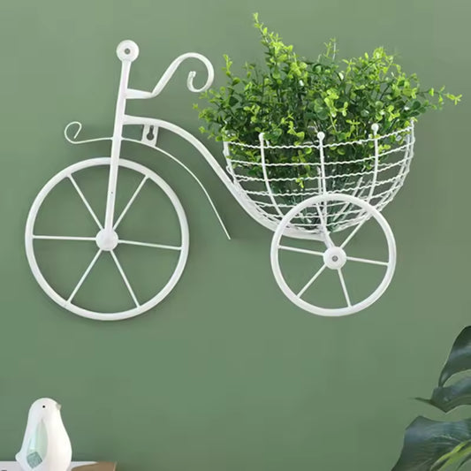 Clarify.pk retro bicycle wall art decor with white metal frame and basket holding green plant on green wall