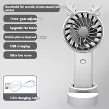White handheld mini fan with phone stand featuring three-gear adjustment and USB charging