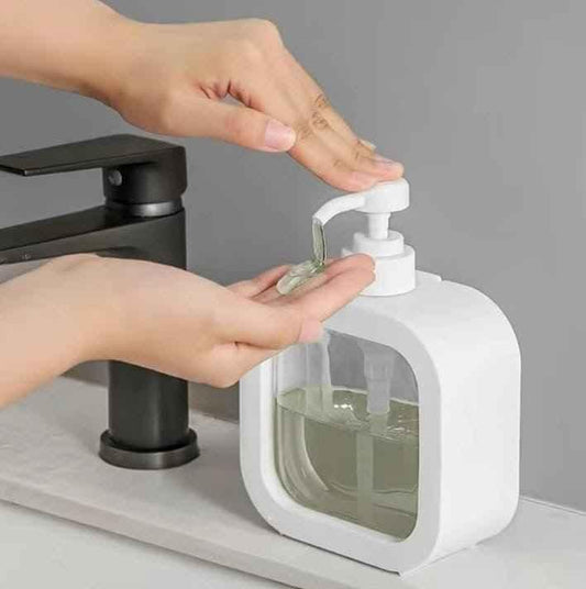 Clarify.pk white Square Soap Dispenser being used with clear liquid soap near black faucet