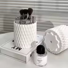Clarify.pk makeup brushes stored in a white textured makeup organizer storage box on a white surface