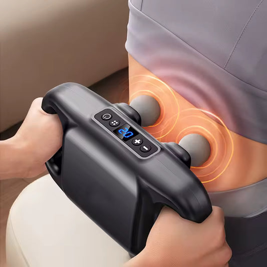 Black 4-head massage gun used on lower back for deep muscle relaxation and pain relief