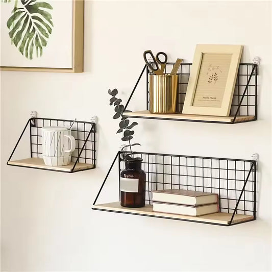 Minimalist wooden iron wall shelf set with black metal grid frame holding books, mug, plant, and stationery