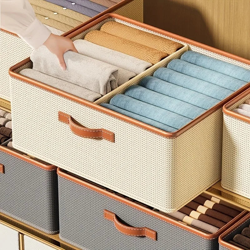 Clarify.pk wardrobe clothing storage box with beige woven design and leather handle organizing folded clothes