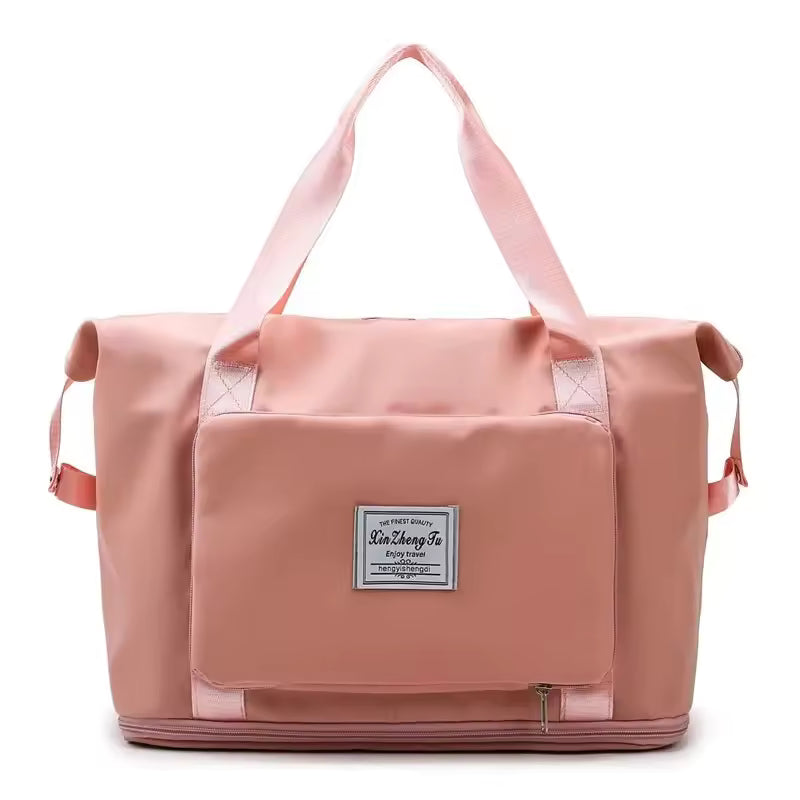 Pink large capacity travel bag with front pocket and sturdy handles for easy carrying