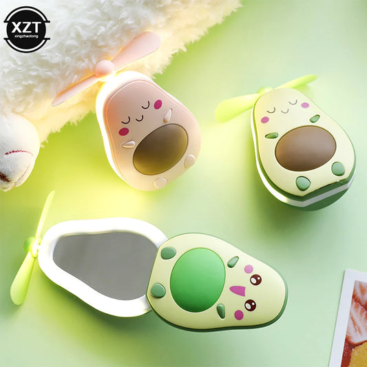 Avocado-shaped portable makeup mirror fan with built-in LED light and small blade fan for personal use