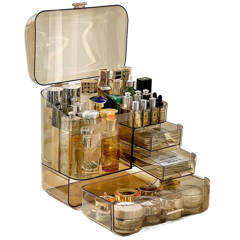 Clear acrylic cosmetics storage box with multiple compartments holding perfumes and skincare products